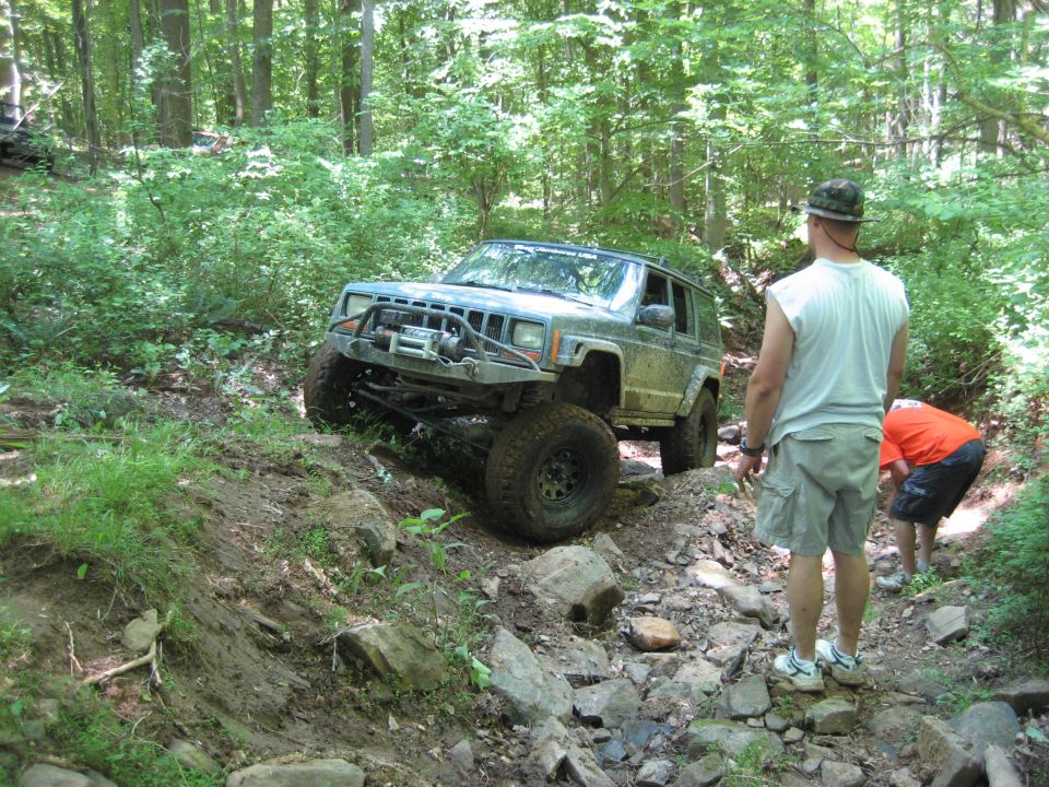 Jeep Cherokee XJ with aftermarket bumper and winch on rocky trail