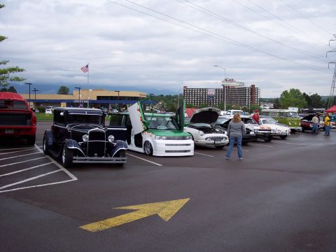 1972 Ford Ranchero - Several vehicles are parked in a lot, including a modified Scion xB with its doors open.