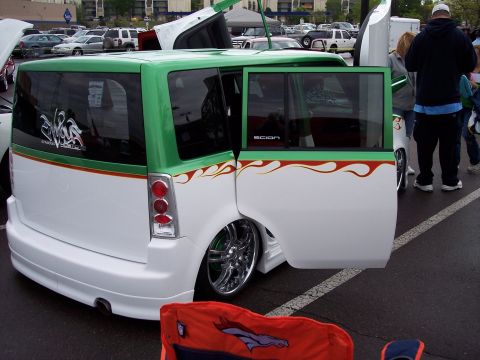 1972 Ford Ranchero - A customized Scion xB is displayed with its doors and hood open in a parking lot.
