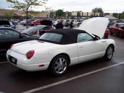 1972 Ford Ranchero - White 2002 Ford Thunderbird convertible with black top, hood open, parked in a lot.