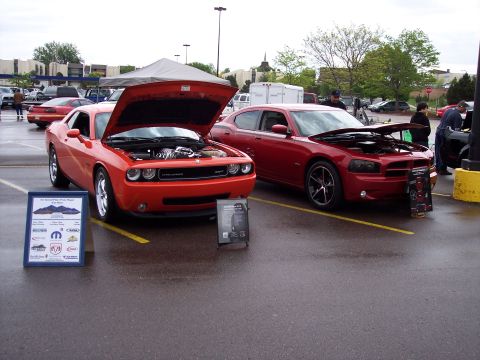 1972 Ford Ranchero - Two Dodge vehicles are displayed with their hoods open at an outdoor event.
