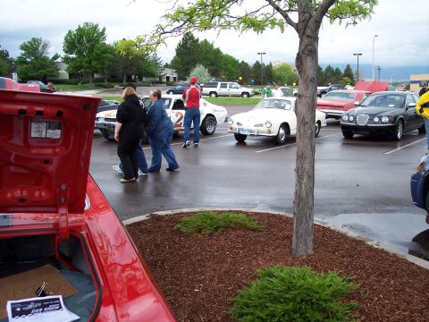 1972 Ford Ranchero - Several vehicles are parked in an outdoor lot, including a white coupe with racing stripes and the number 2 visible.
