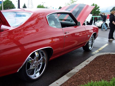 1972 Ford Ranchero - Red muscle car with racing stripes and chrome wheels, hoods open.