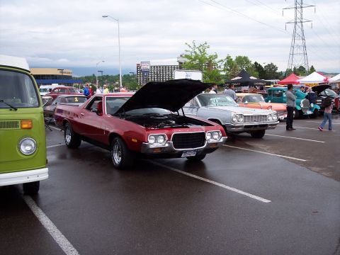 1972 Ford Ranchero - Red 1972 Ford Ranchero on display at a car show with its hood open.