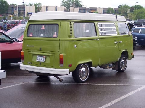 1972 Ford Ranchero - A green Volkswagen Type 2 van with a white camper top is parked in a lot, showing its rear end and license plate.
