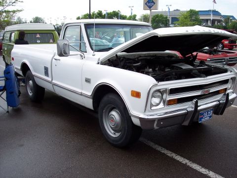 1972 Ford Ranchero - This white Chevrolet pickup truck, likely a 1971 model, is displayed with its hood open, revealing the engine compartment. A Colorado licen…