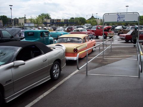 1972 Ford Ranchero - A collection of classic vehicles, including a 1955 Ford Fairlane, parked in a lot under a cloudy sky.