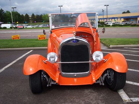 1972 Ford Ranchero - This orange convertible hot rod is parked in a lot with its hood open, showing the engine compartment.