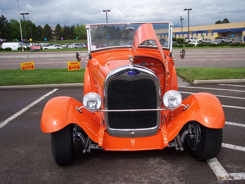 Orange convertible hot rod with hood open, front view