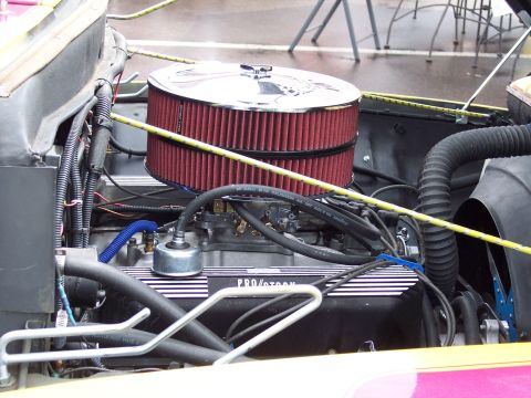 1972 Ford Ranchero - Close-up of an engine bay a prominent chrome air cleaner and "PRO/STORM" branded valve covers.