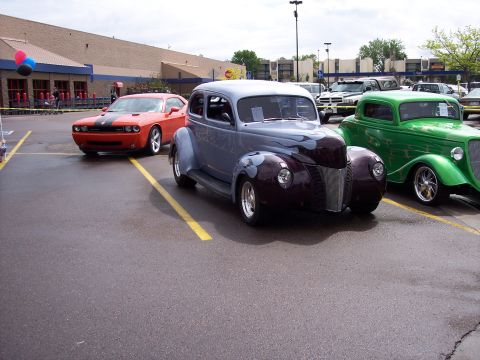 1972 Ford Ranchero - A custom hot rod with flame graphics is parked in a lot next to other vehicles.