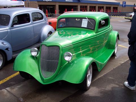 1972 Ford Ranchero - A bright green custom coupe with flame graphics sits in a parking lot, with another classic car beside it.