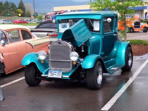 1972 Ford Ranchero - A teal 1929 Ford Model A coupe hot rod is displayed at an outdoor car show.