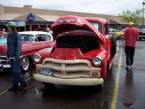 1972 Ford Ranchero - A red Chevrolet truck is parked in front of a Sam's Club with its hood open.