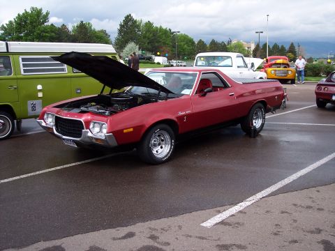 1972 Ford Ranchero - 1972 Ford Ranchero on display with hood up, parked in a lot with other vehicles.