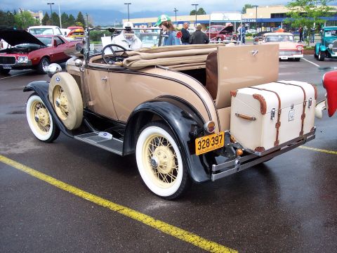1972 Ford Ranchero - Tan 1929 Ford Model A Roadster with a trunk mounted on the back, parked outdoors.