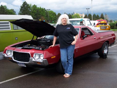 1972 Ford Ranchero - Woman poses with her 1972 Ford Ranchero at an outdoor car event.
