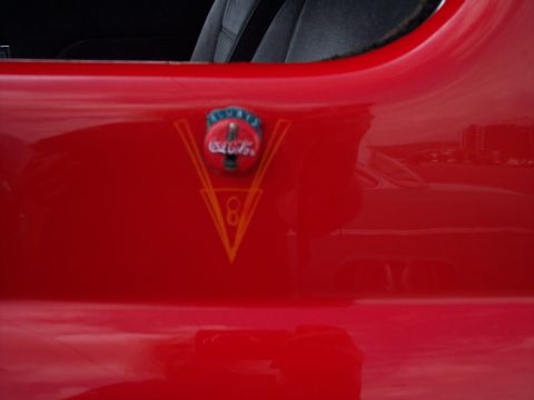 1972 Ford Ranchero - Coca-Cola emblem on a red vehicle's exterior panel, with a V8 graphic below.