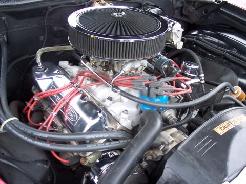 1972 Ford Ranchero - The engine bay of a Ford vehicle, a V8 engine with updated chrome components and an aftermarket air cleaner.