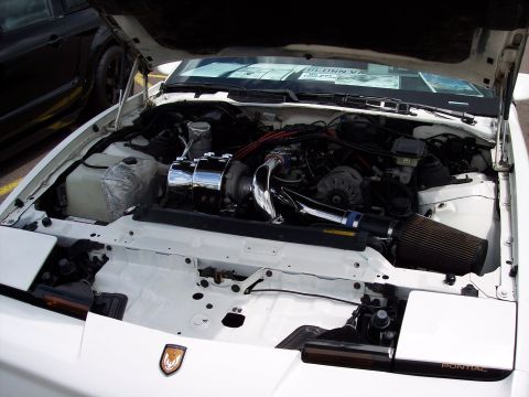 1972 Ford Ranchero - Engine bay of a white Pontiac Firebird, modified with a turbocharger and performance air intake.