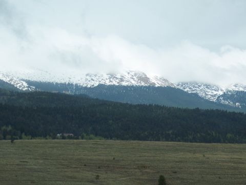 1972 Ford Ranchero - A vast mountain landscape unfolds with snow-dusted peaks and dense forests stretching across the horizon.