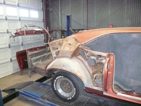 1975 Ford Ranchero - Car body undergoing repairs in a workshop, showing the rear section of a 1975 Ford Ranchero.