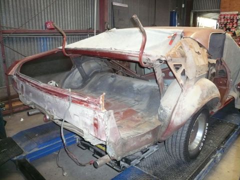 1975 Ford Ranchero - This vehicle is undergoing repairs, with its trunk open and rear section exposed.