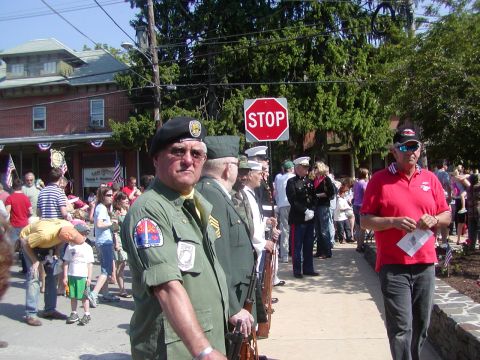 2004 Ford Mustang - Outdoor gathering with individuals in military uniforms and civilian attire.