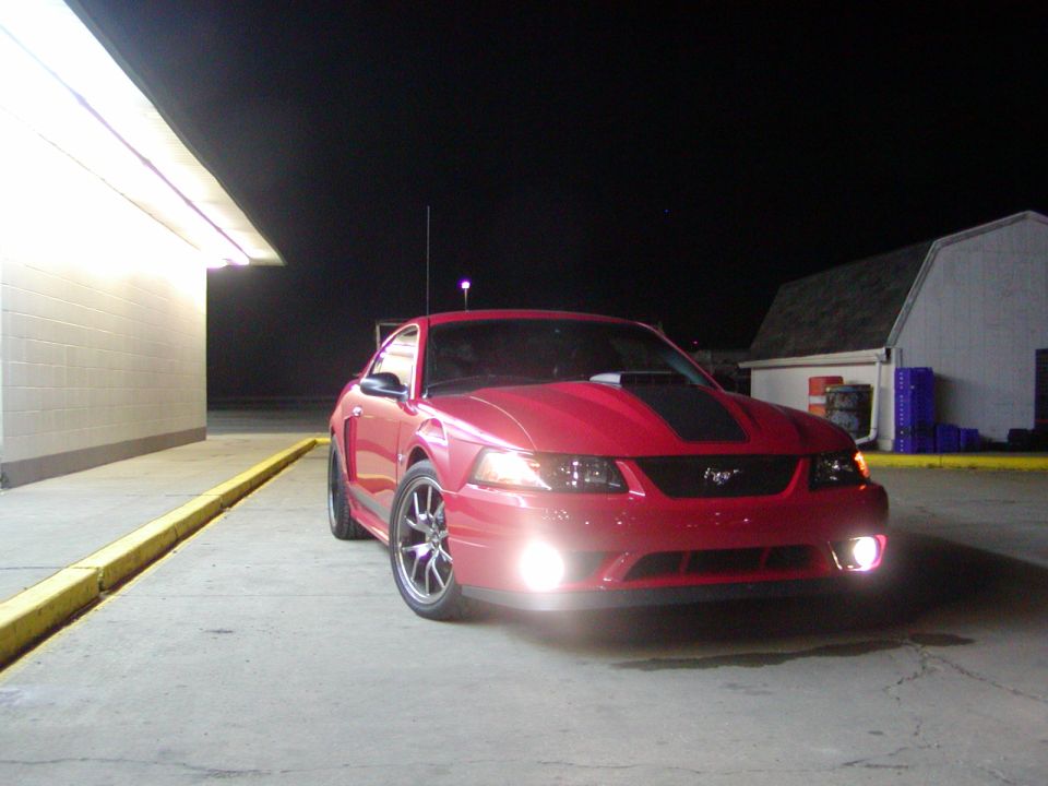 Red 2004 Ford Mustang parked at night