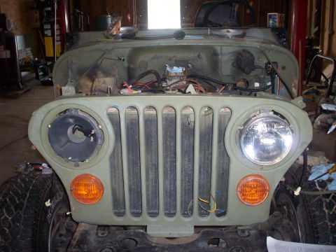 1978 Jeep CJ5 - Front view of a 1978 Jeep CJ5 undergoing restoration, showing the grille and engine bay.