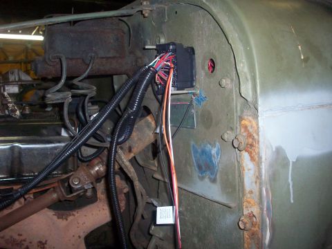 1978 Jeep CJ5 - A close-up view of the engine bay wiring harness in a green Jeep, revealing signs of rust and wear.