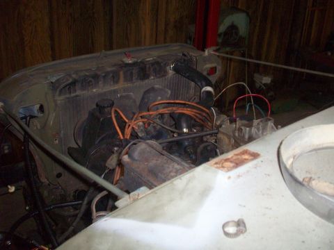 1978 Jeep CJ5 - Close-up view of the engine compartment of a Jeep, with various mechanical components visible.