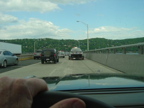 2001 Ford Crown Victoria - A police car, likely a 1998 Ford Crown Victoria, is being transported on a trailer on a highway.