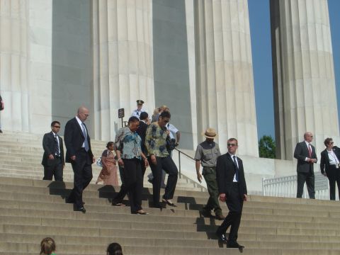 2001 Ford Crown Victoria - A group of people, including individuals in suits and park ranger attire, walk down wide marble steps.