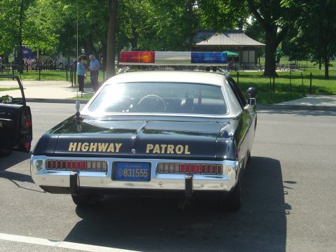 2001 Ford Crown Victoria - This black highway patrol car features a light bar and the words "HIGHWAY PATROL" on the trunk lid.