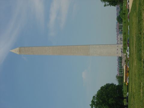 2001 Ford Crown Victoria - The Washington Monument stands tall against a bright blue sky, with a grassy field and trees in the foreground.