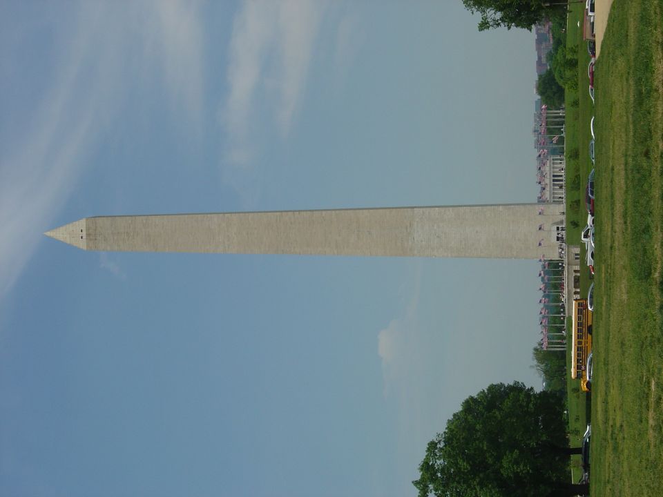 Washington Monument against a blue sky with clouds