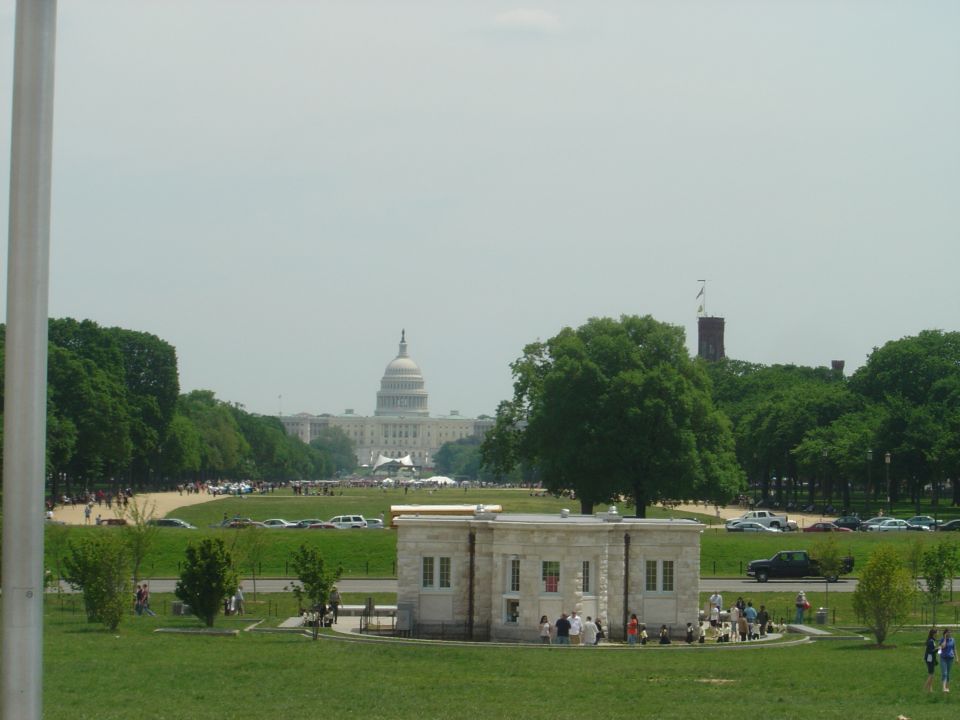Washington DC National Mall with Capitol Building in background, cars parked along the grass