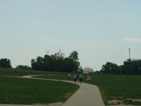 2001 Ford Crown Victoria - A park scene with people walking on a path, a domed building visible in the background.