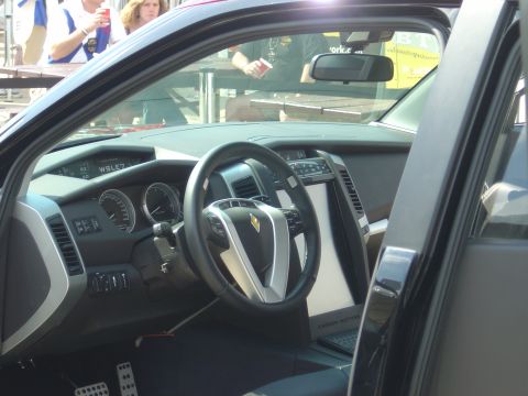 2001 Ford Crown Victoria - Interior view of a car with a prominent touchscreen and a distinctive steering wheel.