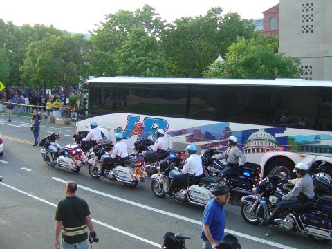 2001 Ford Crown Victoria - Motorcycle police escort a bus with a graphic of the US Capitol building.