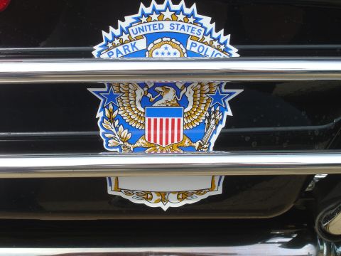 2001 Ford Crown Victoria - Close-up of the United States Park Police emblem on a vehicle's grille.