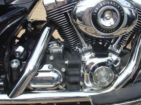 2001 Ford Crown Victoria - Close-up of a Harley-Davidson motorcycle engine, showing chrome details and the 'Police' air cleaner cover.