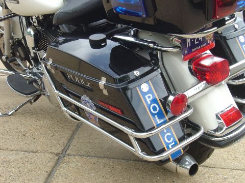 2001 Ford Crown Victoria - Police motorcycle rear view showing saddlebags and lights.