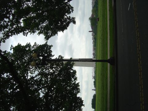2001 Ford Crown Victoria - A view of the Washington Monument on a cloudy day, with trees and a lamppost in the foreground.