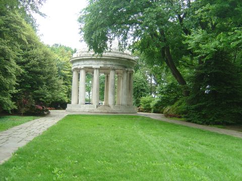 2001 Ford Crown Victoria - A circular monument with columns stands in a grassy park surrounded by trees.