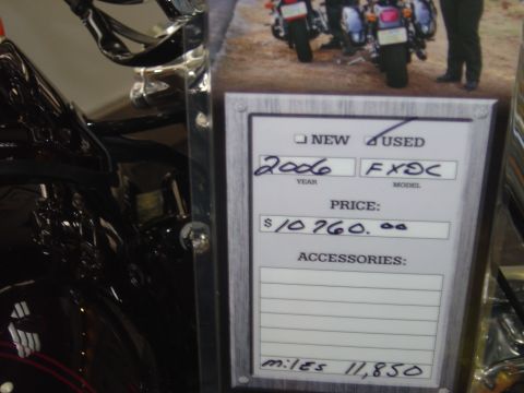 2001 Ford Crown Victoria - A price tag for a used motorcycle lists its year, model, price, and mileage.