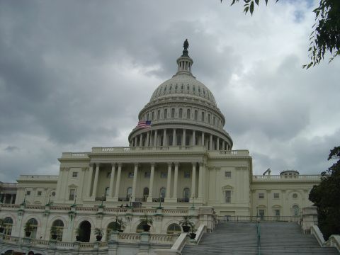 2001 Ford Crown Victoria - The United States Capitol Building stands under a dramatic, overcast sky, its iconic dome a prominent feature.