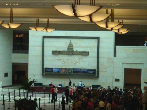 2001 Ford Crown Victoria - A busy scene inside the United States Capitol Visitor Center, showing the main hall with a large display and many visitors.