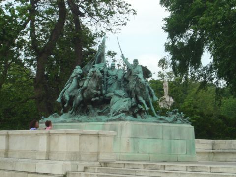 2001 Ford Crown Victoria - A large bronze statue depicts a group of soldiers on horseback, engaged in a dynamic scene with flags.